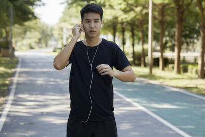 Young man using mobile phone in city