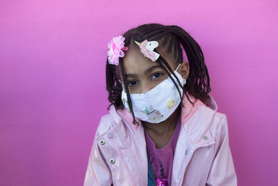 Portrait of girl against pink background