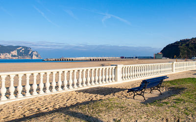 Coastal view with a balustrade and a bench