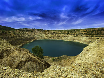 Scenic view of abandoned mine against sky