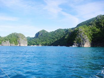 Scenic view of sea and mountains against sky