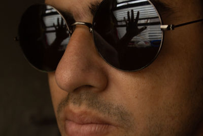 Close-up portrait of young man wearing sunglasses