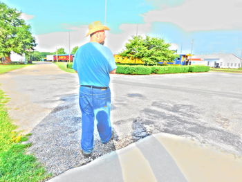 Rear view of woman standing on road