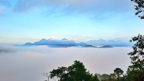 Scenic view of mountains against cloudy sky