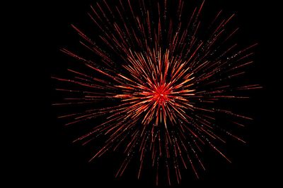 Low angle view of firework display at night