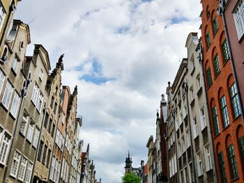 Low angle view of residential buildings against cloudy sky