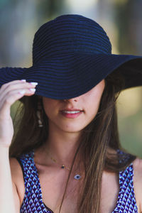 Portrait of young woman wearing sun hat