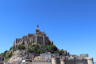 Low angle view of castle against blue sky