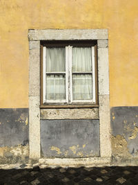 Low angle view of window on old building