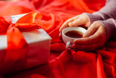 Close-up of hand holding coffee cup