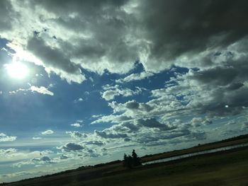 Scenic view of landscape against cloudy sky