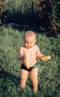 Full length of shirtless baby on field