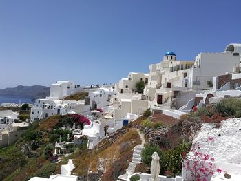 View of cityscape against clear blue sky