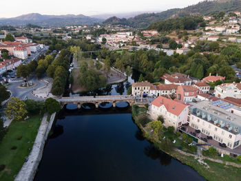 Aerial view of river amidst buildings in town