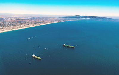 Aerial view of container ship in sea against sky