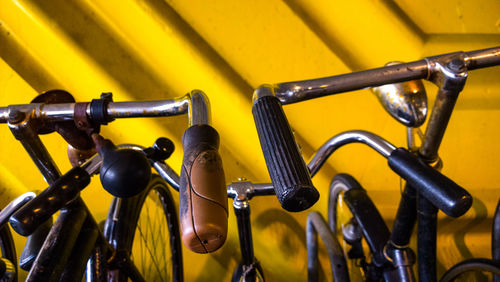 Close-up of bicycles against wall