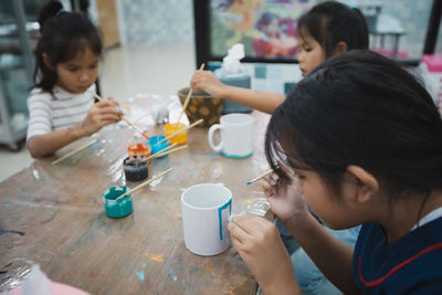 High angle view of people making decoration on table