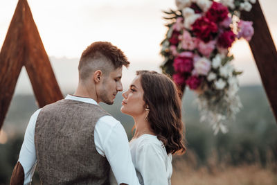 Rear view of couple against plants