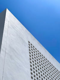 Low angle view of building against clear blue sky