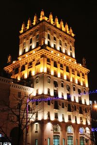 Low angle view of illuminated building against sky at night