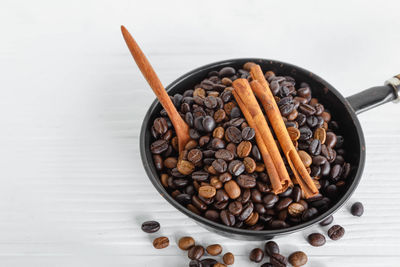 High angle view of coffee beans in bowl on table