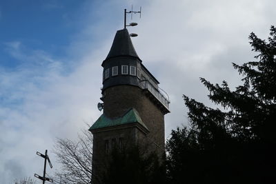 Low angle view of building and trees against sky