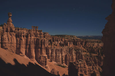 Scenic view of canyon against blue sky