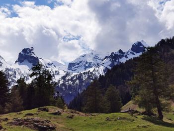 Scenic view of mountains against cloudy sky