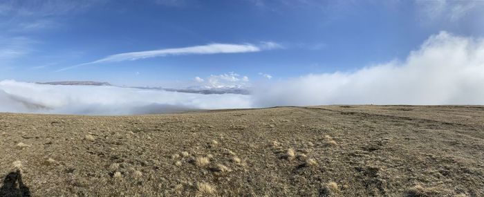 Panoramic view of arid landscape against sky