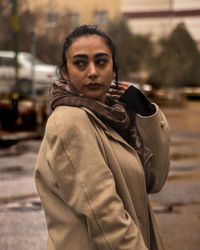 Portrait of young woman standing outdoors