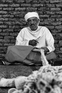 Midsection of man sitting outdoors