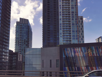 Low angle view of modern buildings against sky in city