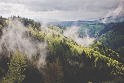 Scenic view of mountains against cloudy sky