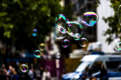 Close-up of bubbles against buildings