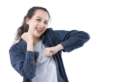 Portrait of a smiling young woman against white background