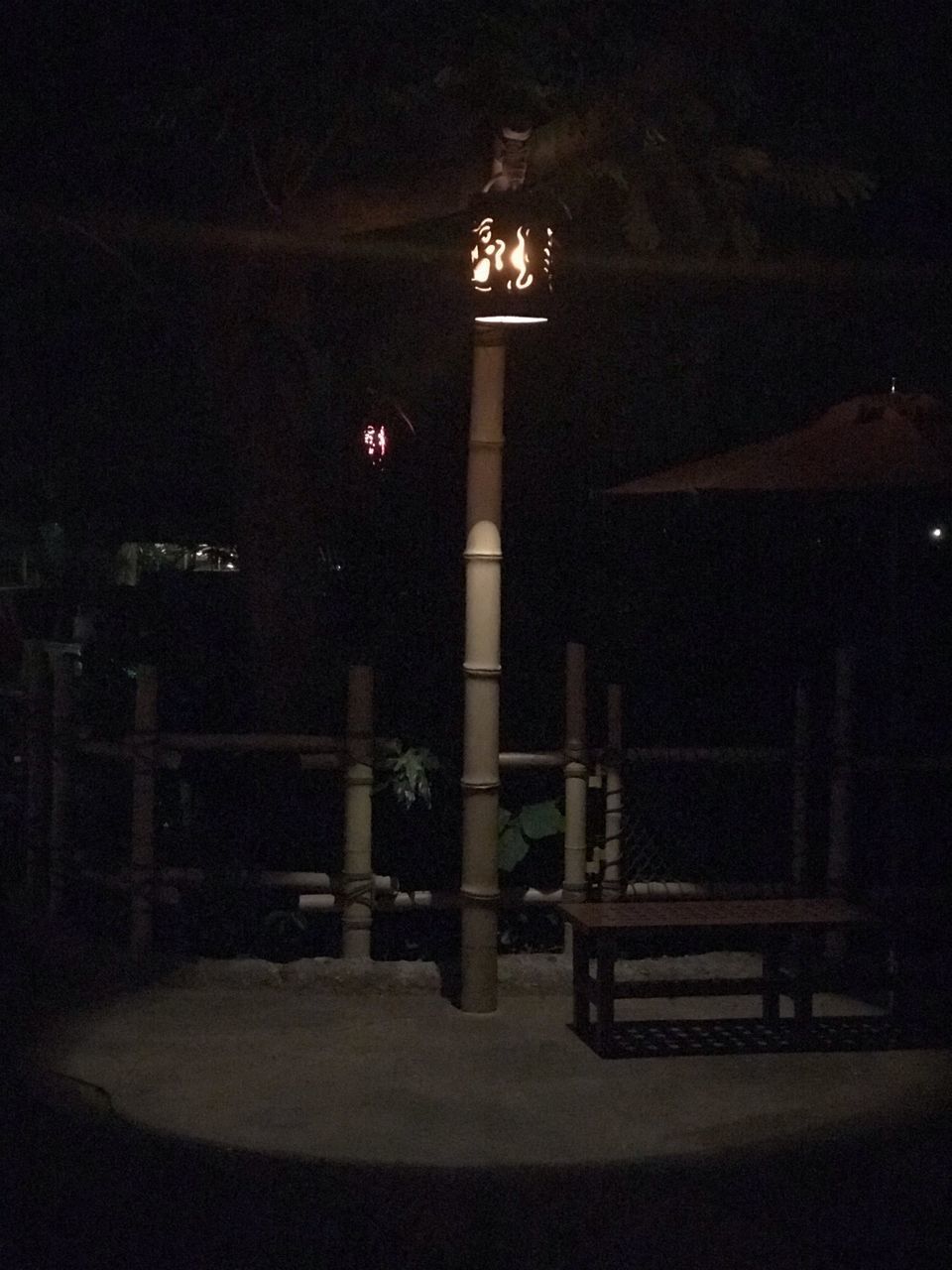 ILLUMINATED STREET LIGHTS AGAINST BUILDINGS AT NIGHT