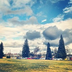 View of trees against cloudy sky