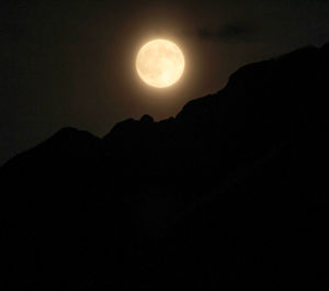 Low angle view of moon in sky at night