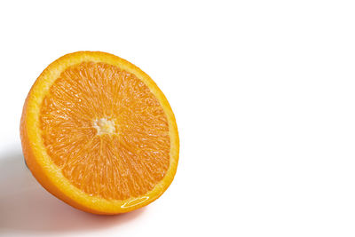 Close-up of orange slice against white background