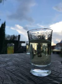 Close-up of drink on table against sky