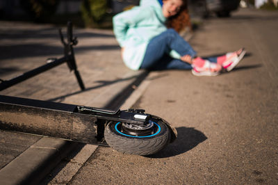 Woman fell from push scooter on road