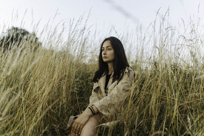 Woman sitting in tall grass