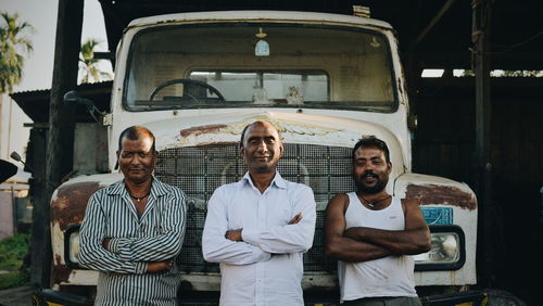 Portrait of friends standing on bus