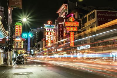 Light trails on road in city at night