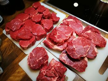 High angle view of different cuts of meat in plate on table