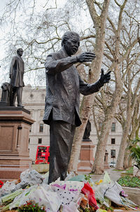 Low angle view of statue against bare trees