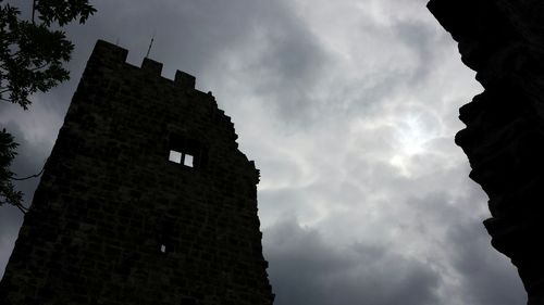 Low angle view of building against cloudy sky