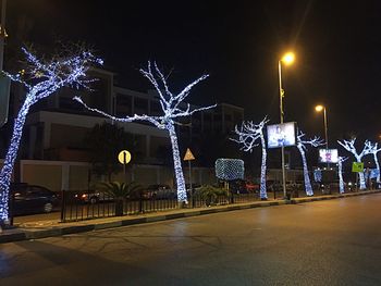 Illuminated christmas lights in city at night