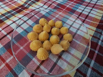 High angle view of yellow flowers on table