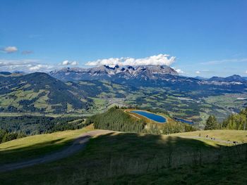 Scenic view of landscape against blue sky